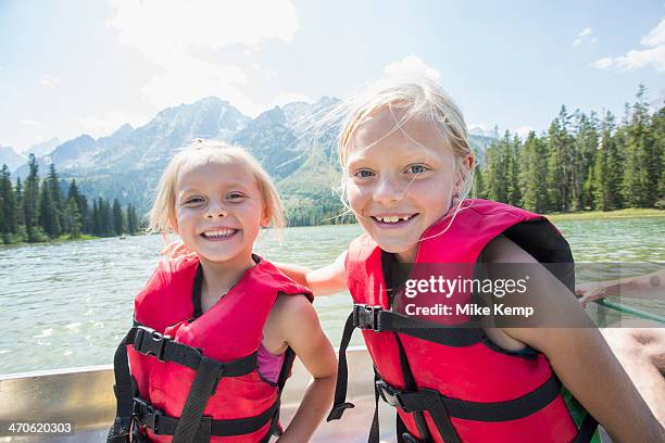 caucasian girls wearing life jackets in canoe - life jacket isolated stock pictures, royalty-free photos & images