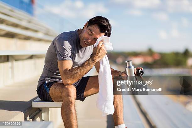 hispanic athlete resting on bleachers - focus on sport 2013 stock pictures, royalty-free photos & images