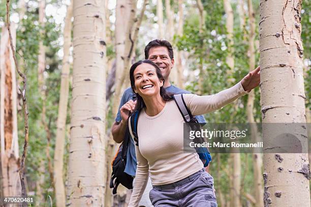 couple walking together in forest - forest walking front stock pictures, royalty-free photos & images
