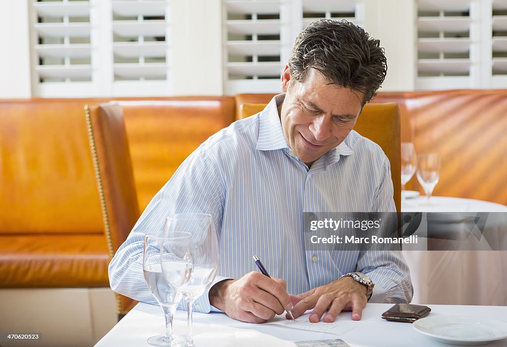 Caucasian businessman working in restaurant