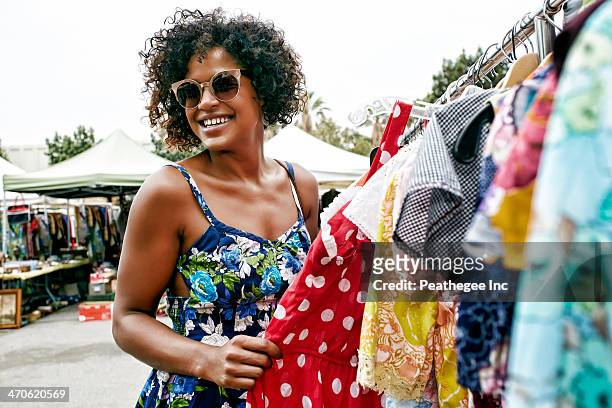 mixed race woman shopping at flea market - flea market stock pictures, royalty-free photos & images