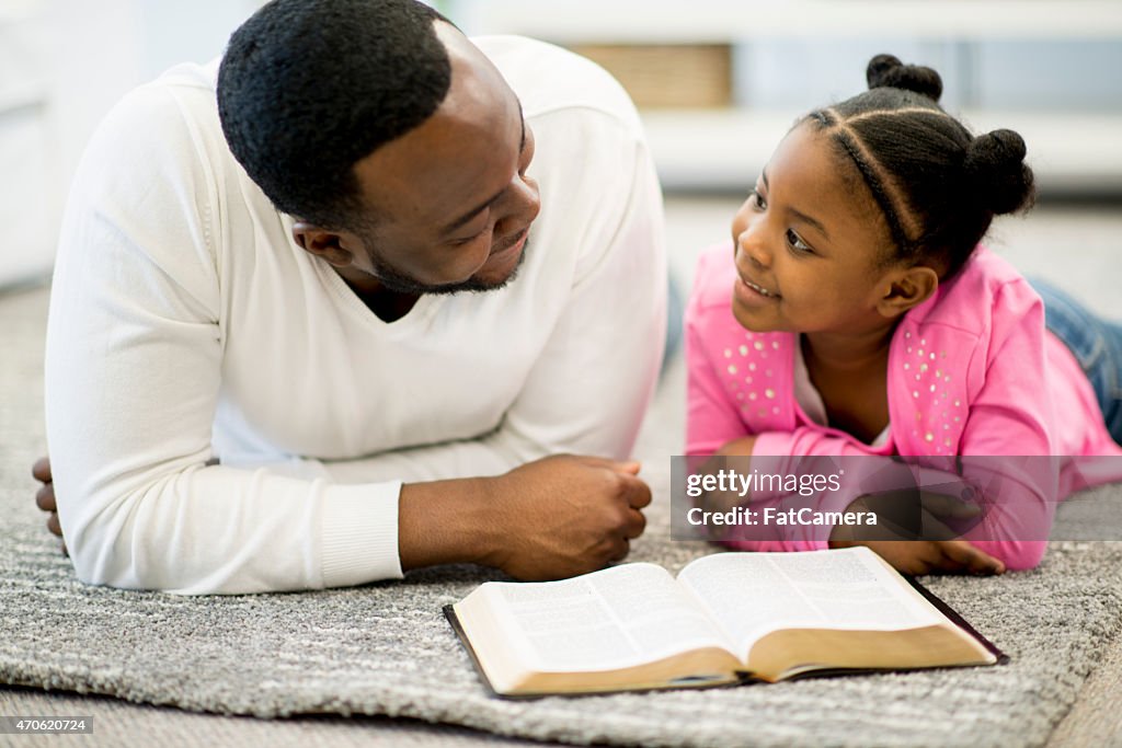 Father and Daughter Studying Bible