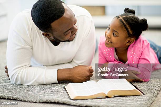 father and daughter studying bible - bible stock pictures, royalty-free photos & images
