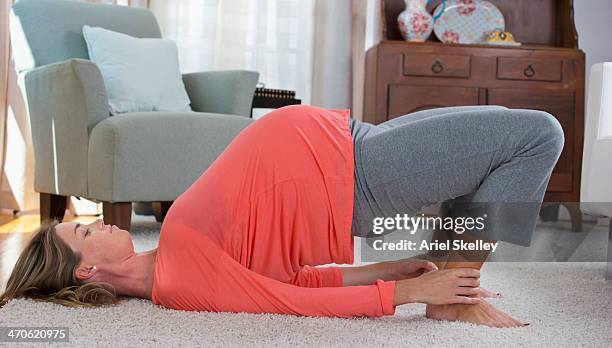 pregnant caucasian woman practicing yoga - pregnant yoga stock-fotos und bilder