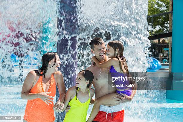 family at water park getting splashed - water park stock pictures, royalty-free photos & images
