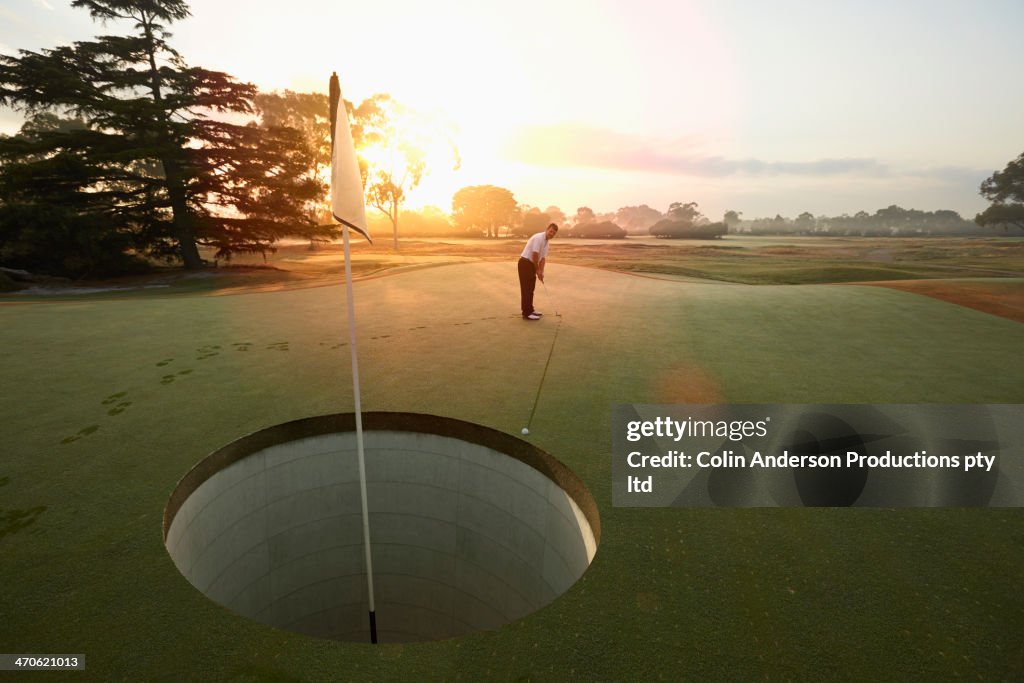 Caucasian man playing golf on course