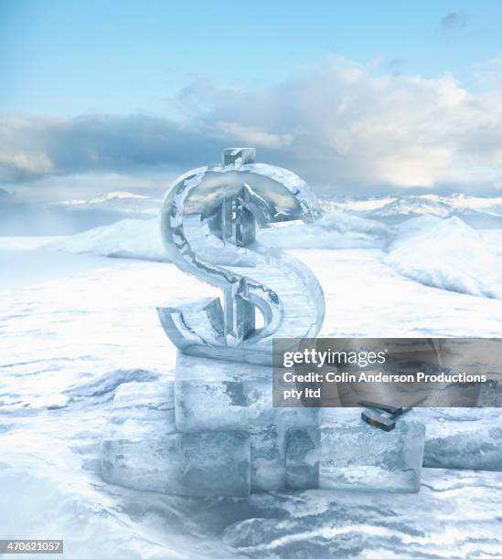 dollar sign on glacial ocean - ice sculpture stock-fotos und bilder