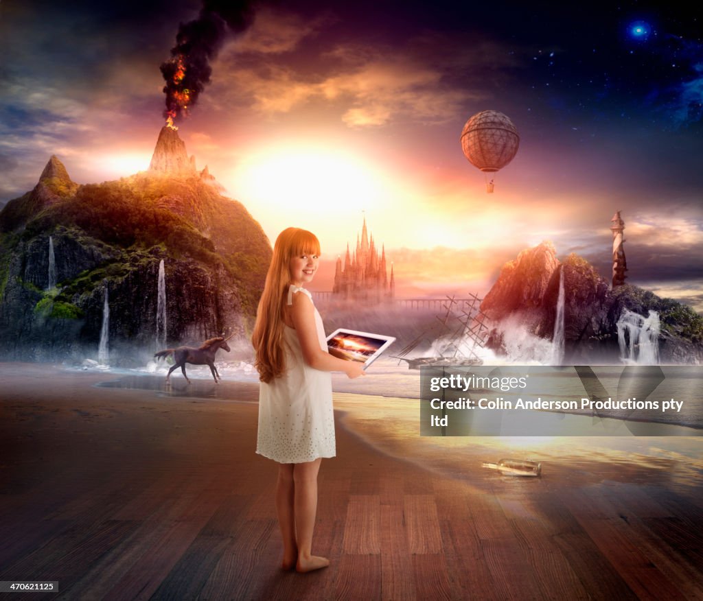 Caucasian girl using digital tablet in dramatic landscape