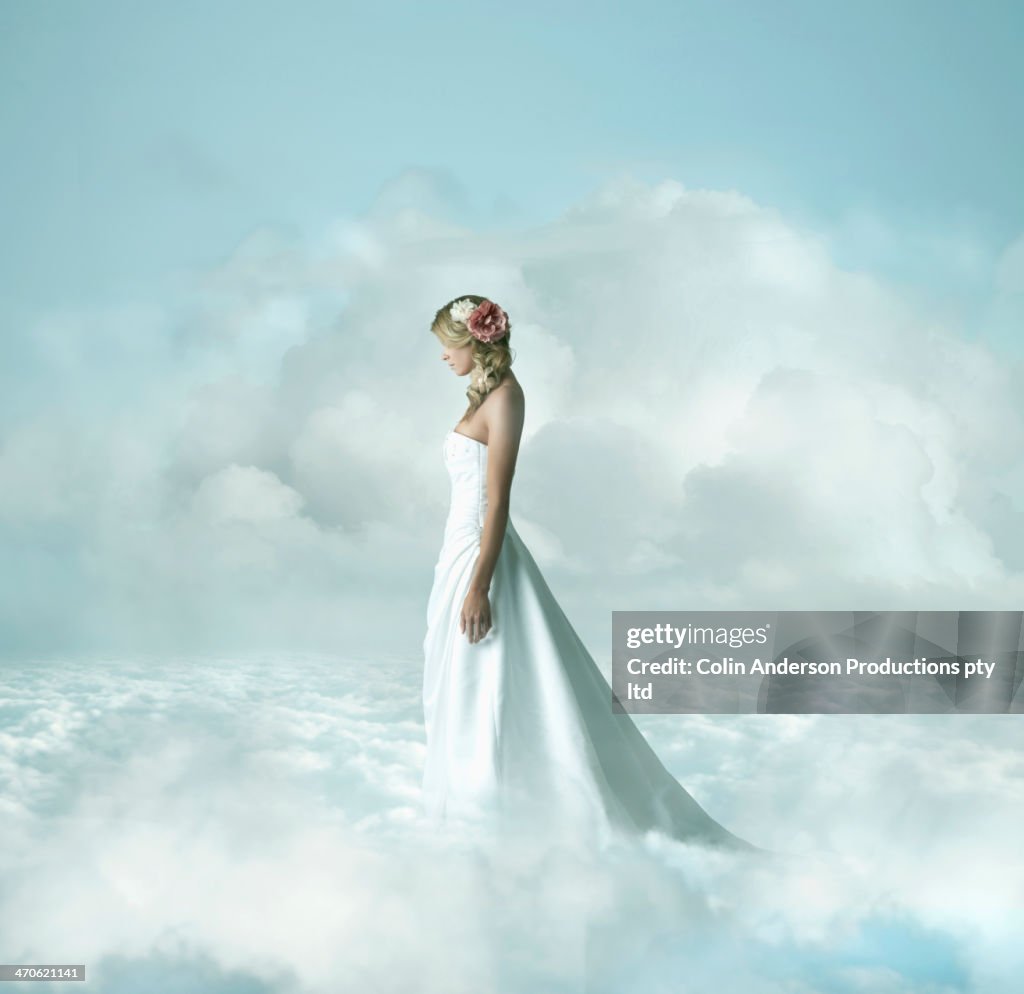 Caucasian bride in clouds