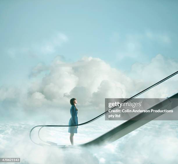 pacific islander woman riding escalator in sky - beginnings concept stock pictures, royalty-free photos & images