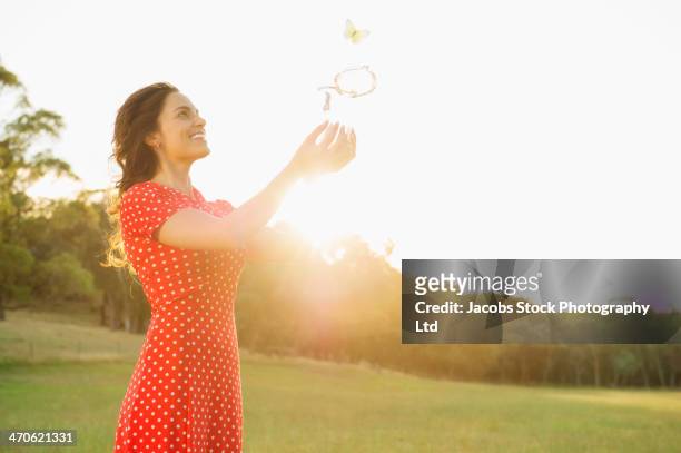 hispanic woman playing outdoors - releasing stock pictures, royalty-free photos & images
