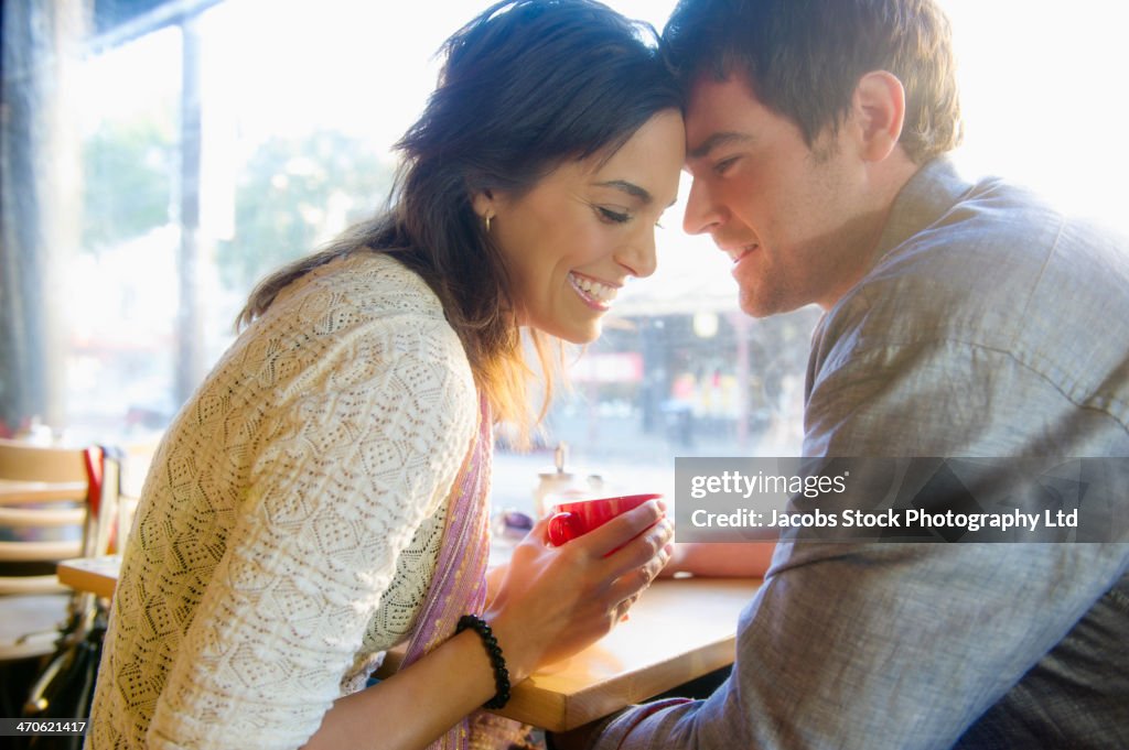 Couple holding hands in cafe