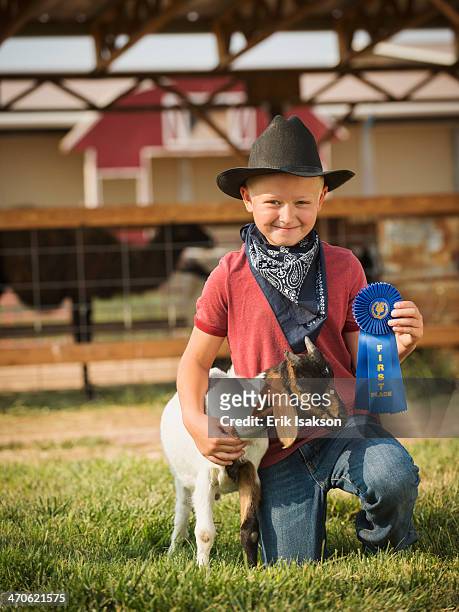 caucasian boy with prize winning goat on farm - animal win fotografías e imágenes de stock