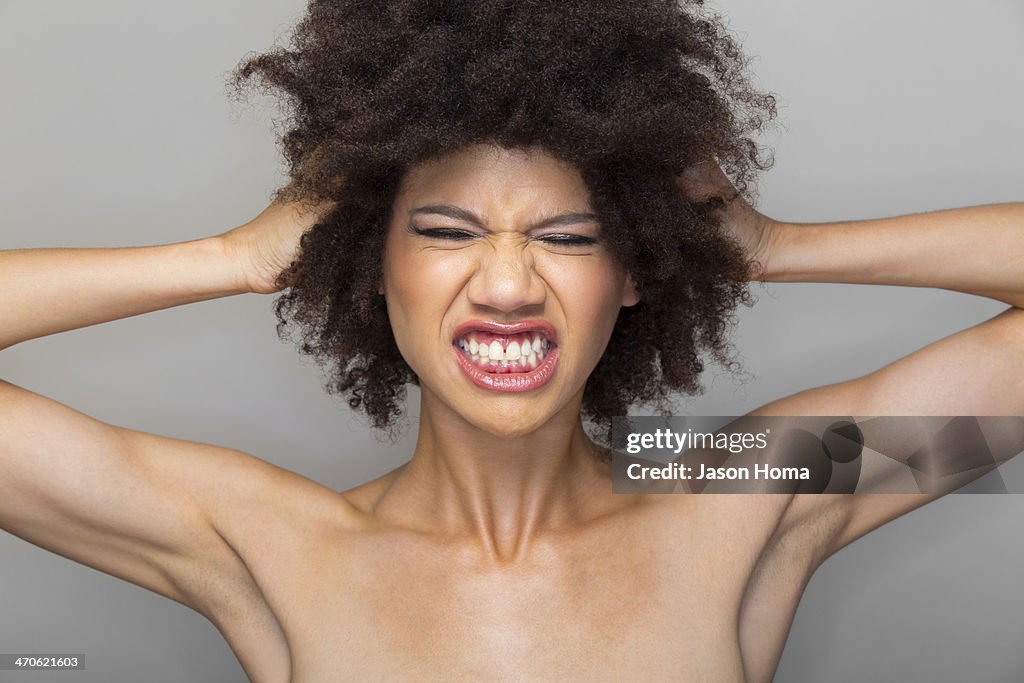 Mixed race woman grimacing