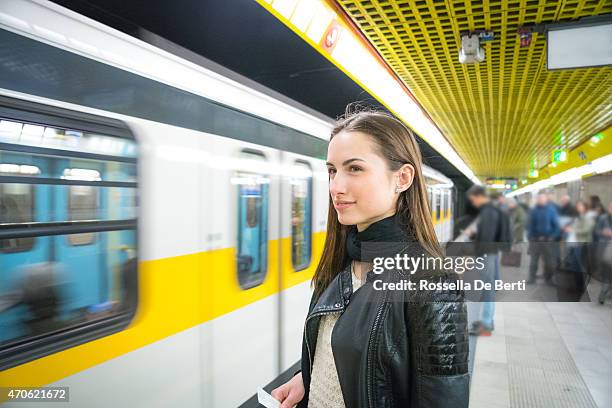 beautiful woman waiting for the subway train - disembarking train stock pictures, royalty-free photos & images