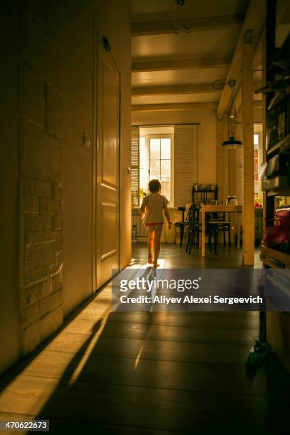 caucasian girl walking in kitchen - kitchen sunlight stock pictures, royalty-free photos & images