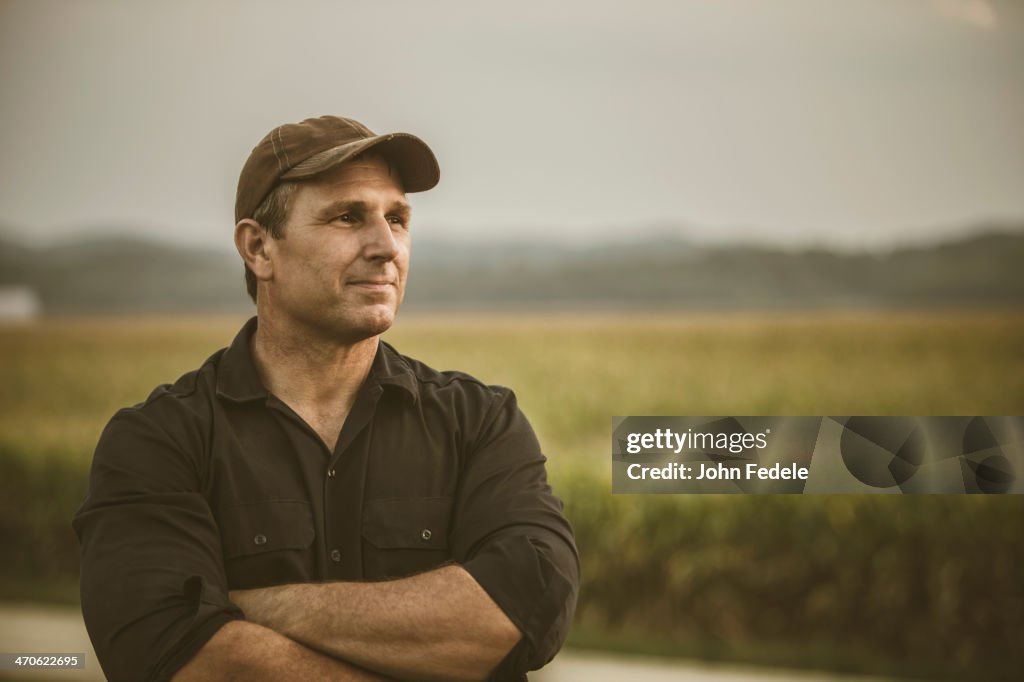 Caucasian farmer overlooking crop fields