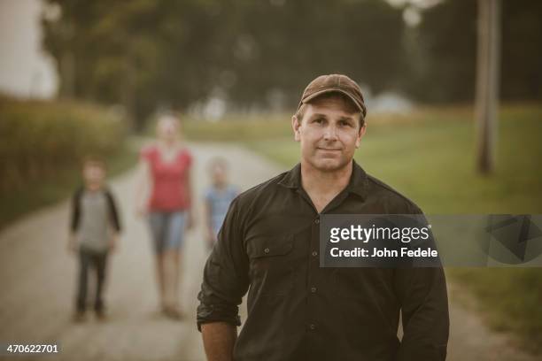 caucasian farmer with family on dirt road - mid adult stock pictures, royalty-free photos & images