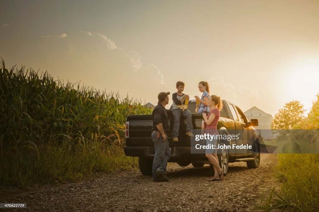 Caucasian family on truck on dirt road