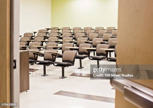 seats in empty lecture hall - college campus stockfoto's en -beelden