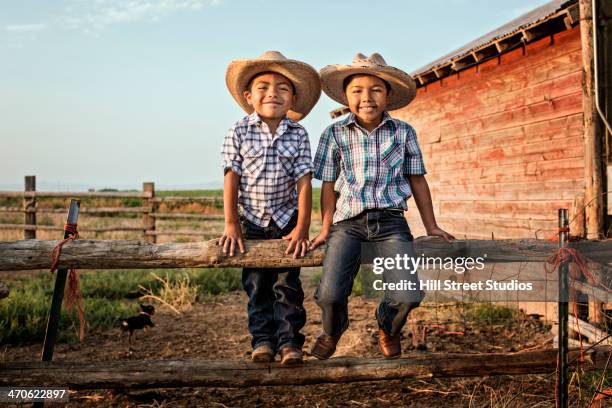 hispanic boys wearing cowboy hats outdoors - confined space worker stock pictures, royalty-free photos & images