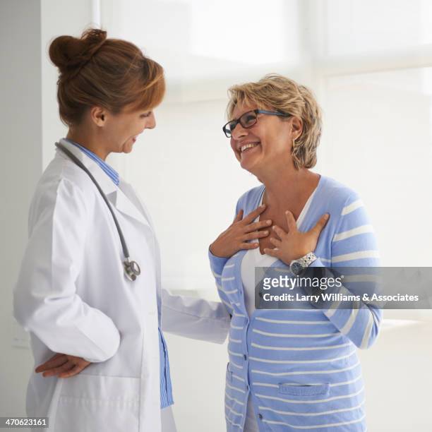 caucasian doctor and patient talking in office - doctor and patient talking imagens e fotografias de stock