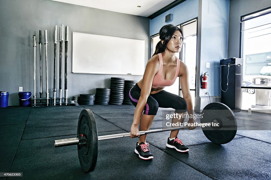 Asian woman working out in gym