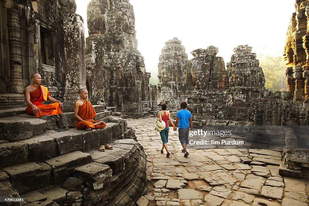 Couple visiting Buddhist temple, Angkor, Siem Reap, Cambodia