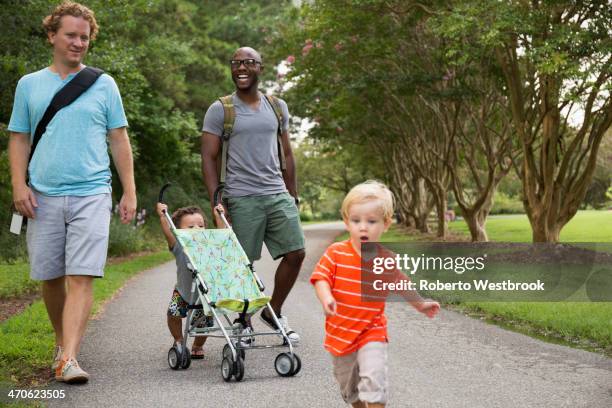 fathers and sons walking together in park - play date imagens e fotografias de stock