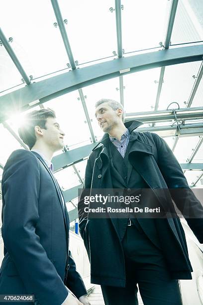 two businessmen on escalator getting in the subway station - crowded underground london stock pictures, royalty-free photos & images