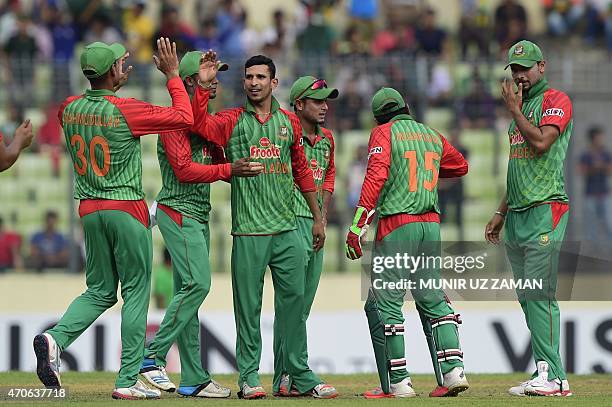 Bangladesh cricketer Nasir Hossain celebrates with his teammates after the dismissal of the Pakistan cricketer Sami Aslam during the third One Day...