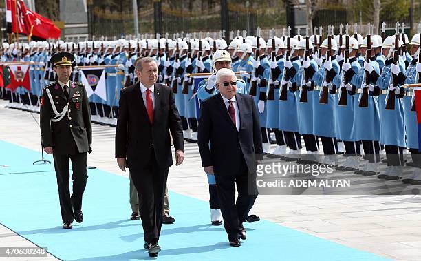Turkish President Recep Tayyip Erdogan and Iraqi President Fuad Masum review the honor guard during an official welcoming ceremony prior to their...