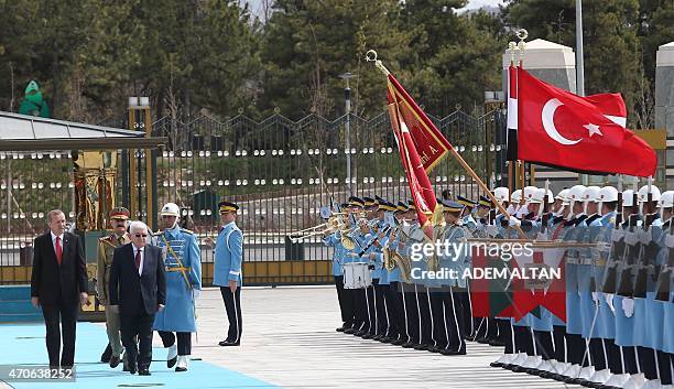 Turkish President Recep Tayyip Erdogan and Iraqi President Fuad Masum review the honor guard during an official welcoming ceremony prior to their...