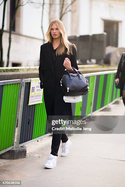 Model Romee Strijd exits the Barbara Bui show in a Givenchy bag and Adidas sneakers at Palais de Tokyo on Day 3 of Paris Fashion Week FW15 on March...