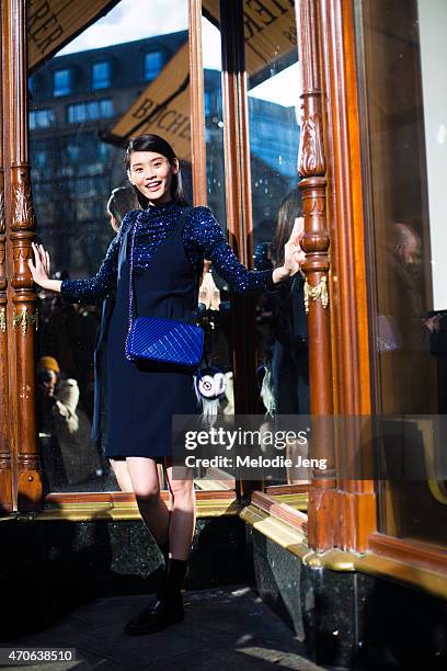 Model Ming Xi exits the Balmain show in a Kiko Mizuhara for Opening Ceremony top, Chanel purse, and Fendi accessory at the Grand Hotel on Day 3 of...