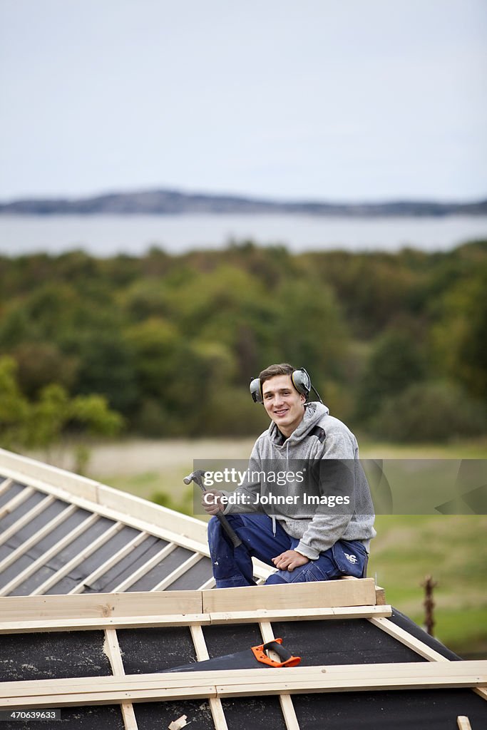 Man working on house roof