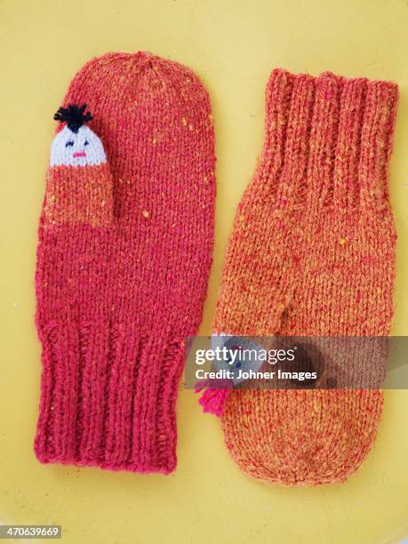 mittens on yellow background, studio shot - mitten stock pictures, royalty-free photos & images