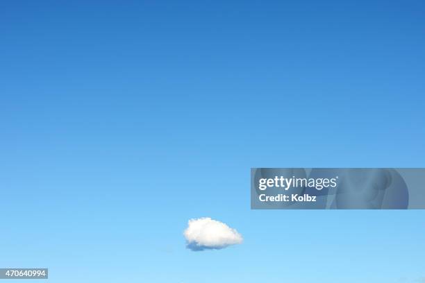 single cloud in clear blue sky - single object stock pictures, royalty-free photos & images