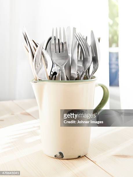 forks in jug - emaille stock-fotos und bilder