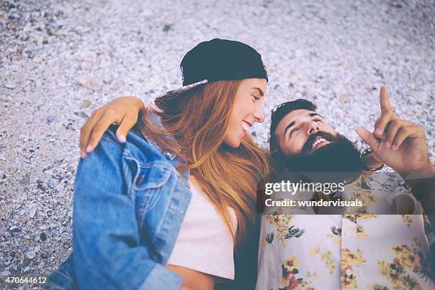 hipster guy pointing to the sky talking to his girlfriend - hipster couple bildbanksfoton och bilder