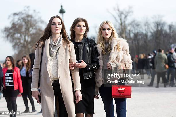 Elite models Josephine Le Tutour, Valery Kaufman, and Harleth Kuusik exit the Elie Saab show at the Tuileries on Day 5 of Paris Fashion Week PFW15 on...