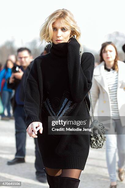 Supermodel Anja Rubik exits the Elie Saab show at the Tuileries in a Redemption Choppers sweater dress, Chanel bag, and Anthony Vaccarello boots on...