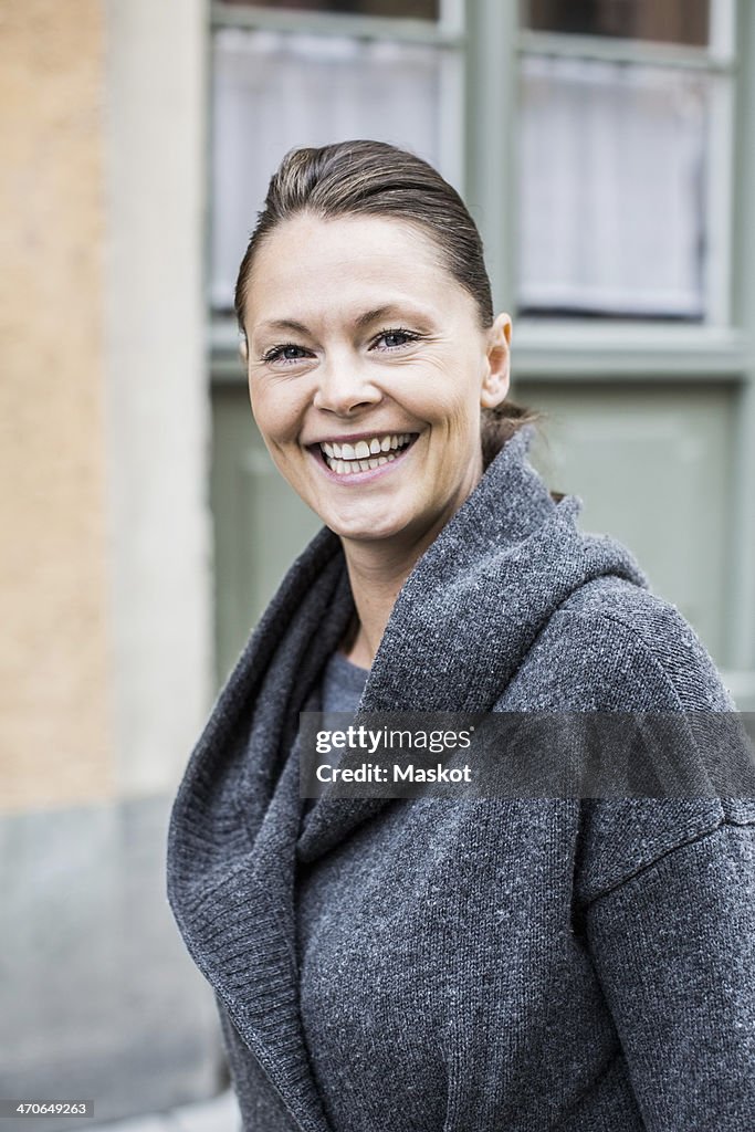 Portrait of happy woman in warm clothing outdoors