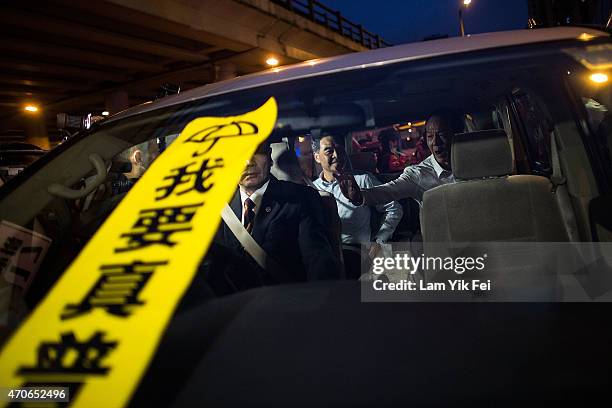 Banner with the Chinese characters 'I want real universal suffrage' placed by the pro-democracy protesters on a window of the vehicle in which Hong...