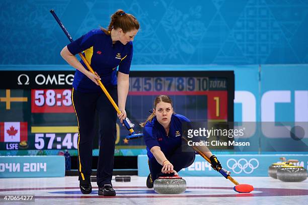 Maria Wennerstroem of Sweden places a stone while Christina Bertrup of Sweden watches during the Gold medal match between Sweden and Canada on day 13...