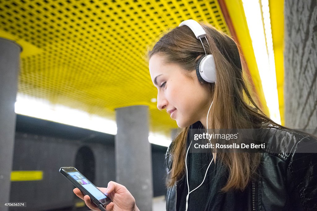 Beautiful Woman Listening Music On Her Smartphone, Subway Station