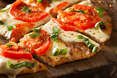 Homemade thin crust pizza with tomato topping