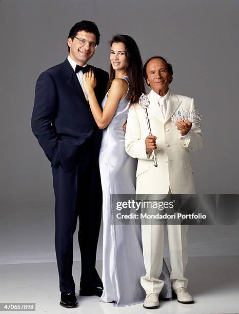 Host of the 1999 edition of Miss Italia, Fabrizio Frizzi, is portrayed in a tuxedo, together with the winner of previous year beauty contest Gloria...