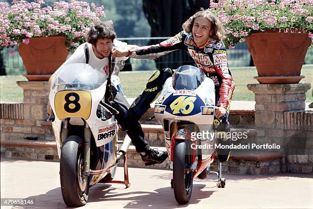 "Italian champion Valentino Rossi photographed with his father Graziano, also a professional motorcycle racer in his youth, pretending to hit him...