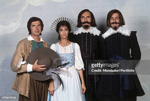 "The members of Il Trio, together with TV host Pippo Baudo, are posing in the stage costumes of the TV drama ""The Betrothed"", satirically adapted...
